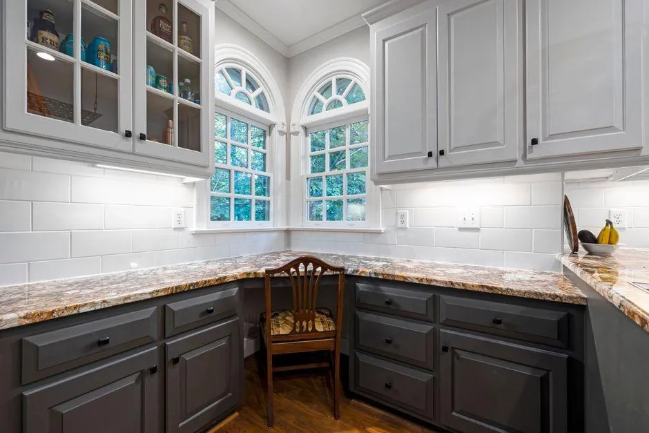 Two-tone painted cabinets with light gray uppers and charcoal lowers